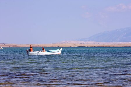 NIN, CROATIA - JUNE 28, 2011: A couple in a small fishing boat on the seaのeditorial素材