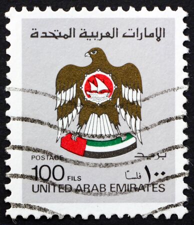 UNITED ARAB EMIRATES - CIRCA 1982: a stamp printed in UAE shows national arms, circa 1982のeditorial素材