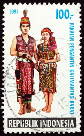 INDONESIA - CIRCA 1990: a stamp printed in Indonesia shows traditional wedding attire from Central Java, circa 1990のeditorial素材