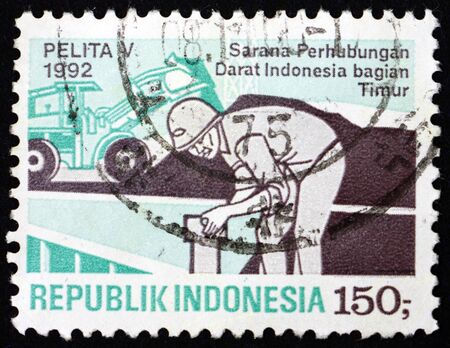 INDONESIA - CIRCA 1992: a stamp printed in Indonesia shows construction worker, five year development plan, circa 1992のeditorial素材