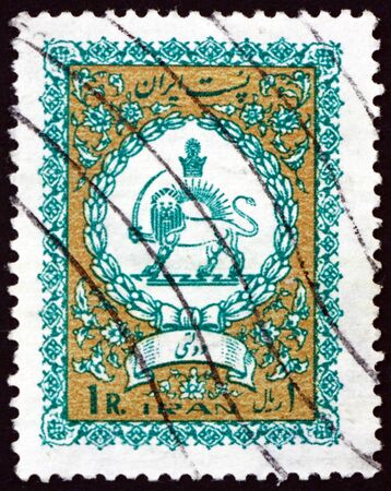 IRAN - CIRCA 1941: a stamp printed in the Iran shows coat of arms of Iran, circa 1941のeditorial素材
