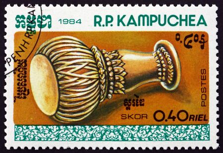 CAMBODIA - CIRCA 1984: a stamp printed in Cambodia shows skor drum, Cambodian traditional musical instrument, circa 1984のeditorial素材