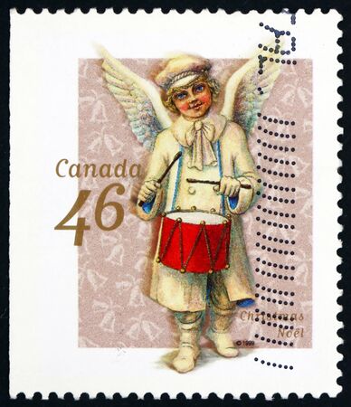 CANADA - CIRCA 1999: a stamp printed in Canada shows angel and drum, Christmas, circa 1999のeditorial素材