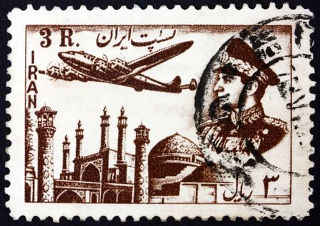 IRAN - CIRCA 1953: a stamp printed in Iran shows Plane above Mosque, and Mohammad Reza Shah Pahlavi, circa 1953のeditorial素材