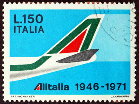 ITALY - CIRCA 1971: a stamp printed in Italy shows tail of B747 in shape of A, Italian airlines...