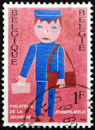 BELGIUM - CIRCA 1969: a stamp printed in Belgium shows mailman, youth philately, circa 1969のeditorial素材