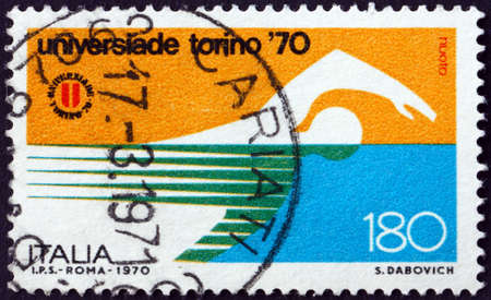 ITALY - CIRCA 1970: a stamp printed in Italy shows Swimmer, 1970 World University Games, Turin, circa 1970の写真素材