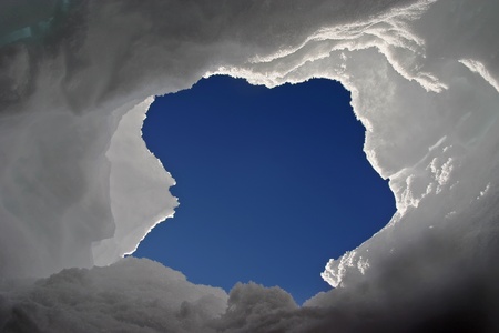 Kind on the sky through a window in snowの写真素材