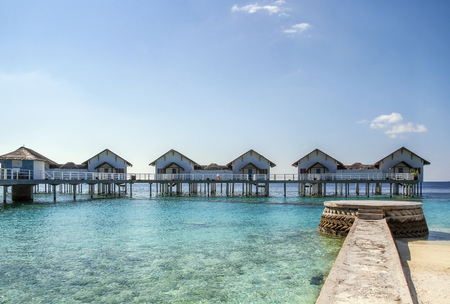 Picturesque bungalows on stilts near the shore of a tropical island, Maldivesの写真素材