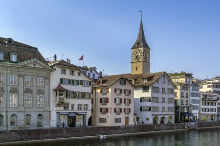 embankment of Limmat river with view of St. Peter church in Zurich, Switzerlandの写真素材