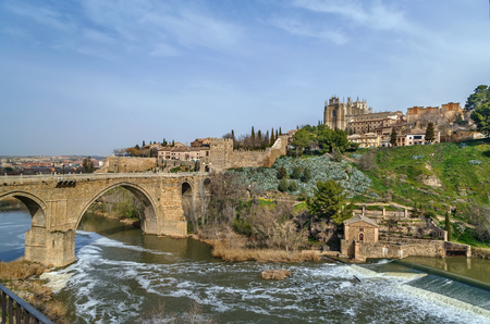 Panoramic view of  Monastery of San Juan de los Reyes (Monastery of Saint John of the Monarchs) with bridge over Tagus river, Toledo, Spainのeditorial素材