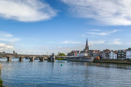 View of embankment of Meuse river with bridge in Maastricht, Netherlandsのeditorial素材