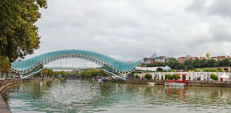 Panoramic view of Kura river with bridge of Peace in Tbilisi, Georgiaの写真素材