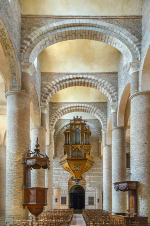 Saint-Philibert de Tournus is a medieval church, the main surviving building of a former Benedictine abbey in Tournus, France. Interior, nave with organのeditorial素材