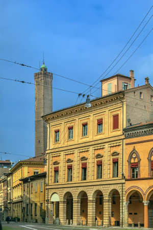 Street in historic center of Bologna with view of tower, Italyの写真素材