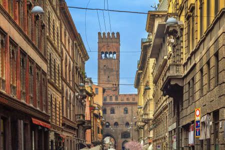 Street in historic center of Bologna with view of tower, Italyの写真素材
