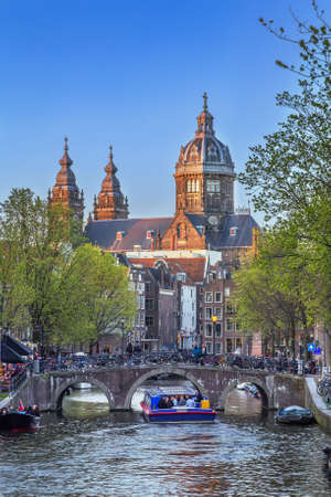 View of canal with basilica of St. Nicholas, Amsterdam, Netherlandsの写真素材