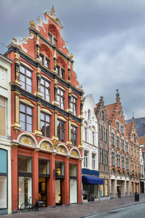 Street with historical houses in Bruges city center, Belgiumの写真素材