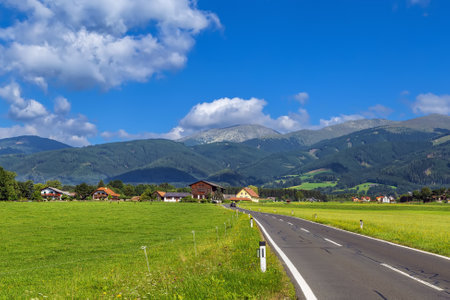 View of fields and Alps mountains in central Styria, Austriaの写真素材