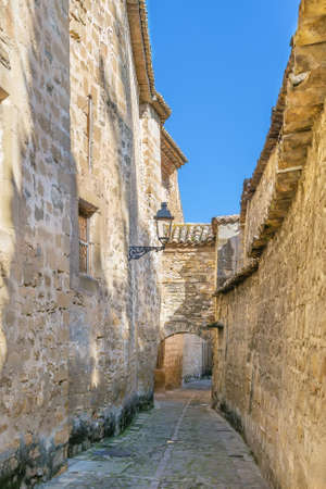 Street with stone walls in Baeza, Spainの写真素材