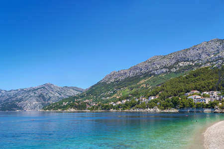 View of the shore of the Adriatic Sea with mountains in the background in the district of Brela, Croatiaの写真素材