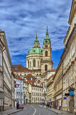 Street with Church of Saint Nicholas in Prague, Czech Republicの写真素材