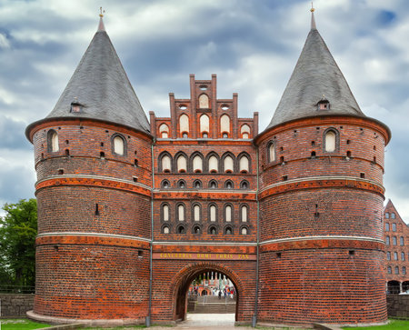 Holsten Gate is a city gate marking off the western boundary of the old center of the Hanseatic city of Lubeck, Germanyの写真素材