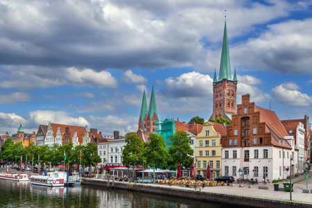 Historic houses on the Trave River embankment in Lubeck city center, Germanyの写真素材