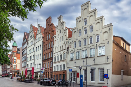 Historic houses on the Trave River embankment in Lubeck city center, Germanyの写真素材