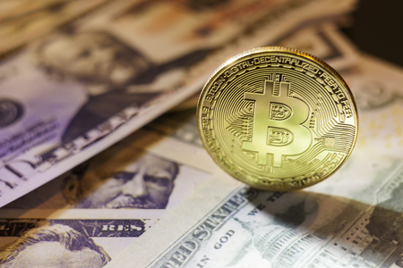 golden bitcoin coin on us dollars close upの写真素材