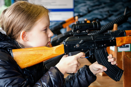 girl shoots a rifle in the city amusement parkの写真素材