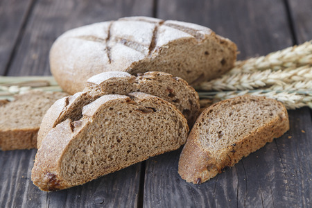 sliced bread with wheat ears on a wooden table