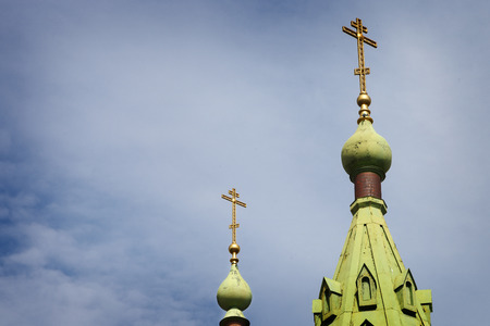Orthodox cross on the dome of the Church against the blue skyの写真素材