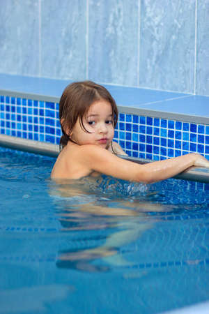 The child learns to swim in the poolの写真素材
