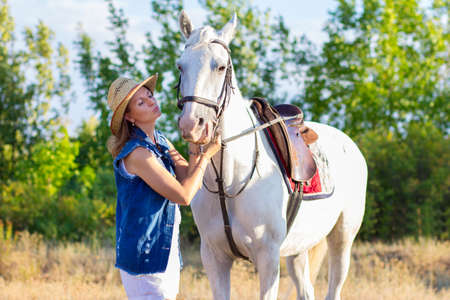 The girl in shorts embraces a horseの写真素材