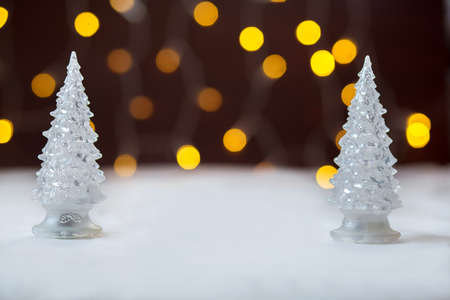 Two toy New Year trees against the background of firesの写真素材