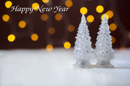 Two toy New Year trees against the background of fires. Inscription Happy New Yearの写真素材
