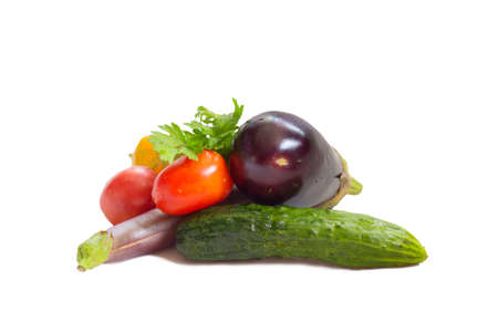 Still life from multi-colored vegetables on a white background. Eggplant, cucumber, tomato, pepper, greensの写真素材