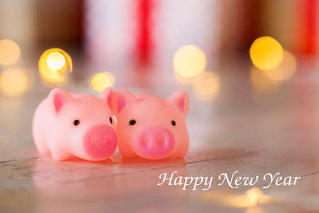 Two toy a pig against the background of New Year's scenery, bokeh. Inscription Happy New Yearの写真素材