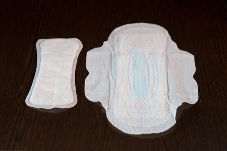 Women's sanitary pads daily and for critical days lie next to a dark backgroundの写真素材