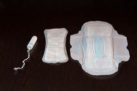 Feminine hygiene devices for menstruation on a table on a black backgroundの写真素材