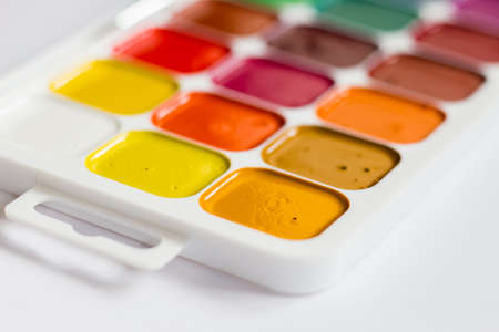 Multi-colored bright Watercolor paints on a table close up.の写真素材