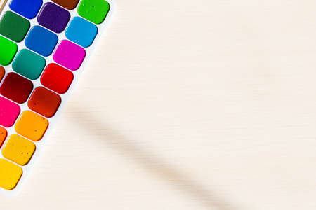 Multi-colored bright Watercolor paints on a table.の写真素材