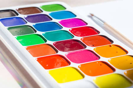 Multi-colored bright Watercolor paints with a brush.の写真素材