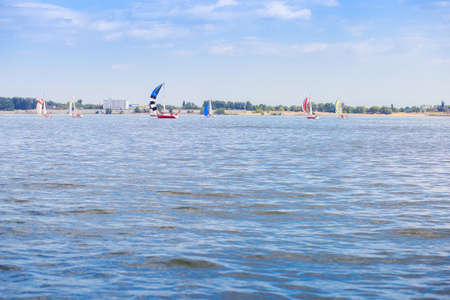 Sailing regatta is on the Volga River near the city of Volgograd. Many yachts with sails on the waterの写真素材