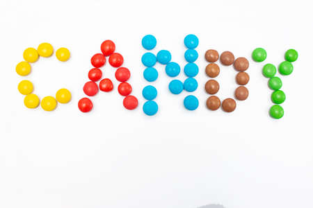 The inscription Candy written in round small multi-colored sweets drageesの写真素材