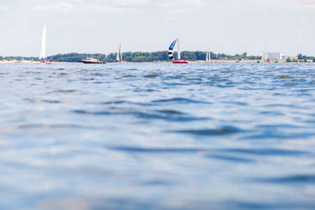 View of the river water, in the background you can see yachts and boats with sailsの写真素材