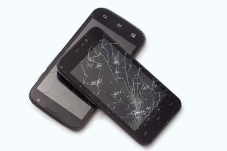 Two broken black smartphones lie the friendの写真素材