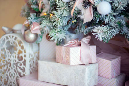 Christmas tree decoration close-up. Christmas tree decor elements. Background for postcards. Beautifully wrapped giftsの写真素材