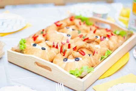 Baby croissants, decorated in the form of crabs for a children's birthday. Table decoration. Baby food, baby sandwiches.の写真素材